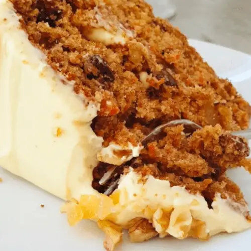 carrot cake made with crystalized ginger, walnuts and dates, topped with a mascarpone cream cheese frosting.