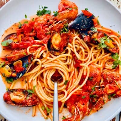 Italian-style seafood marinara with prawns, clams, and mussels in tomato sauce over spaghetti