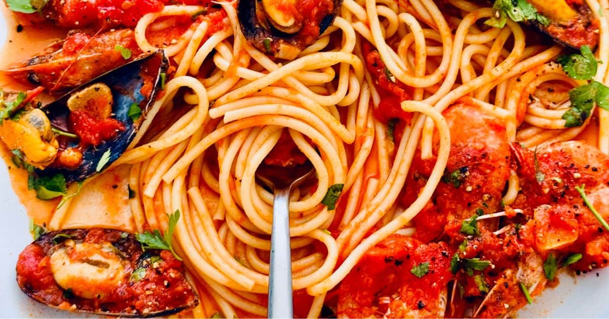 seafood marinara with a fork swirled around the spaghetti
