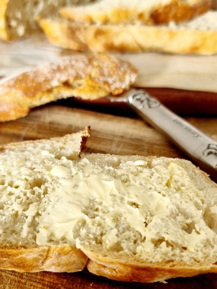 easy no knead bread with butter and a knife