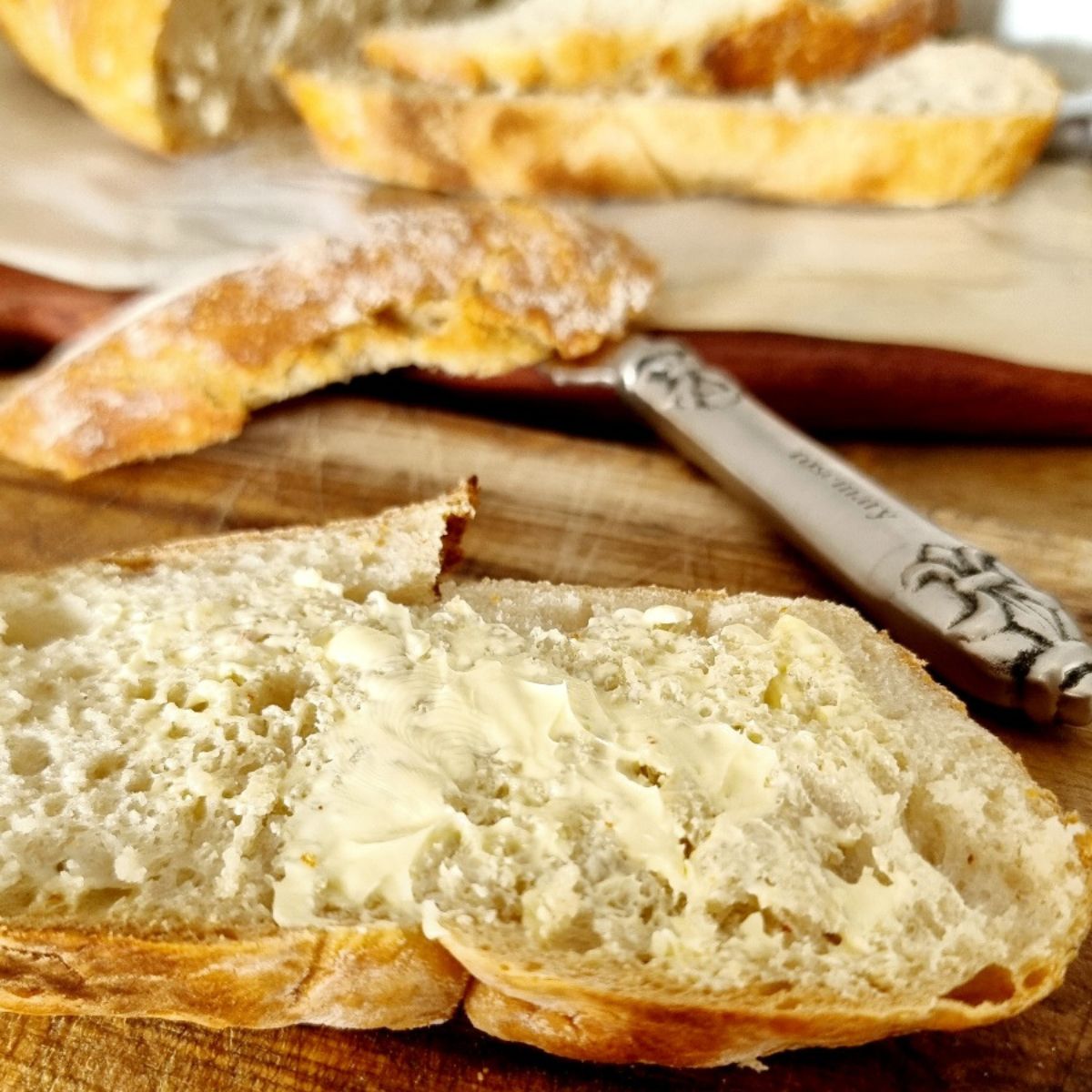 easy no knead bread with butter and a knife