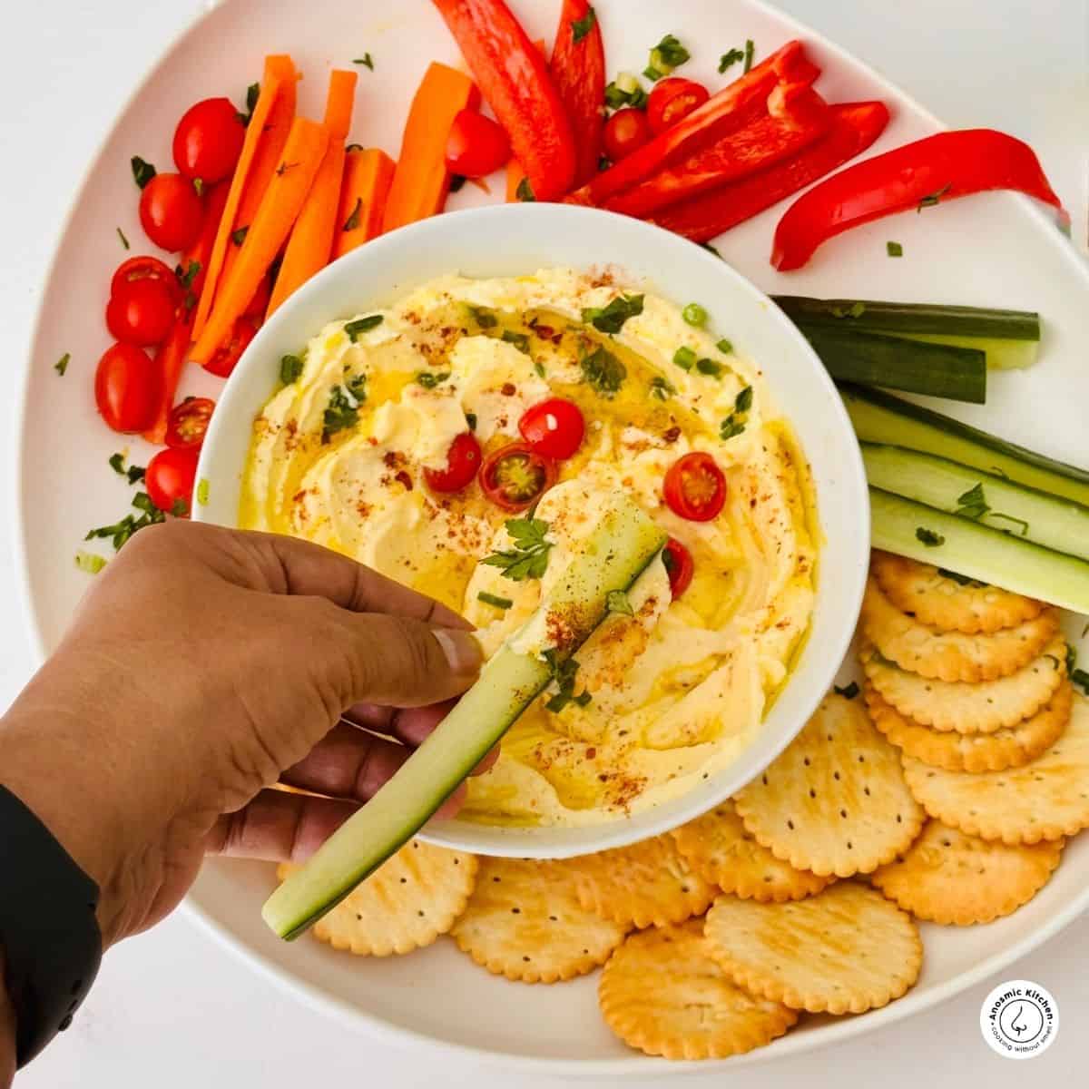 mascarpone cheese dip on a platter with veggies and crackers