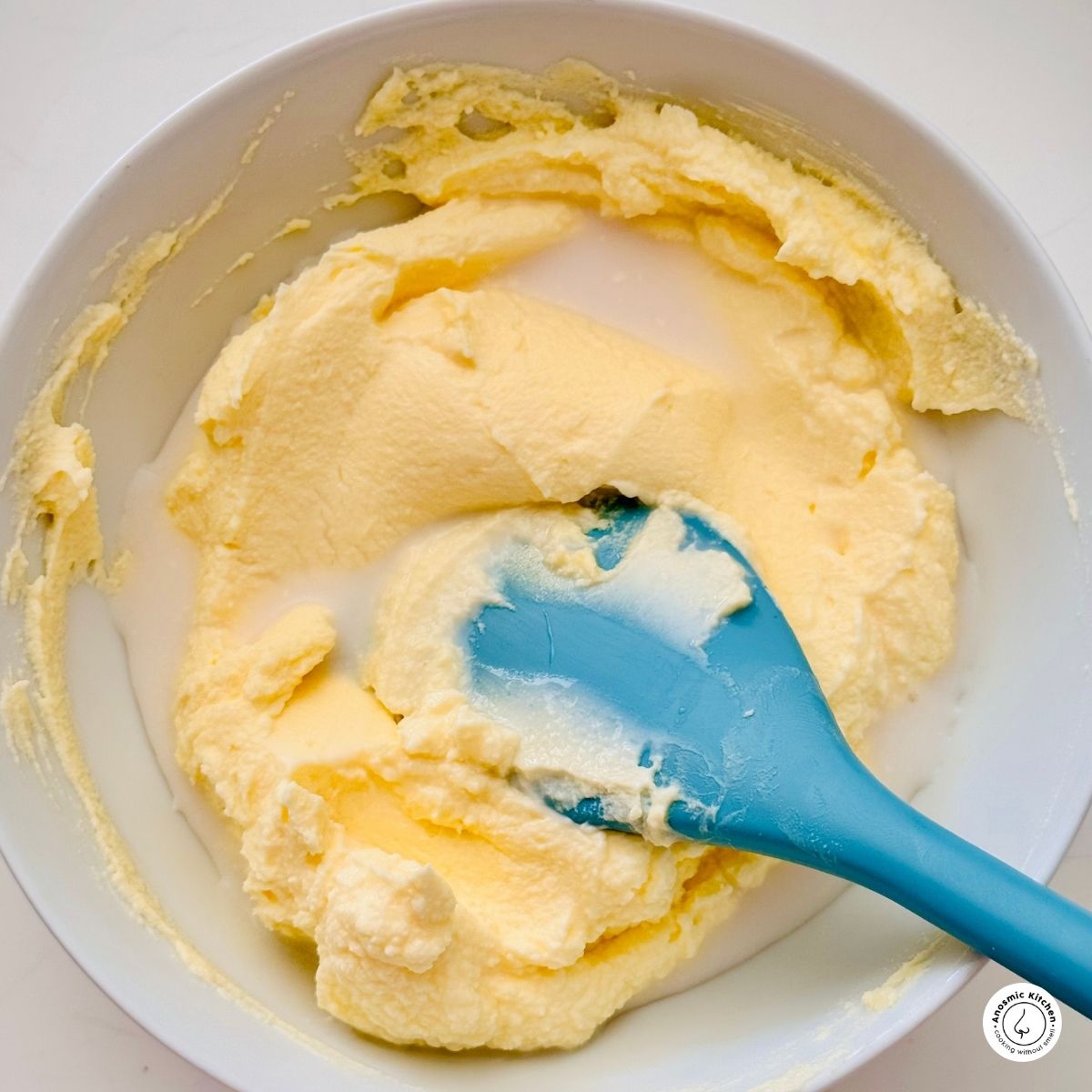 mascarpone cheese mix in a white bowl with milk