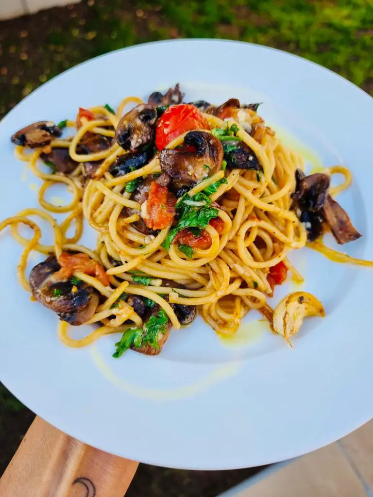 Quick pasta recipe made using spaghetti, tomatoes, mushrooms, olive oil, parmesan cheese, parsley and seasoning