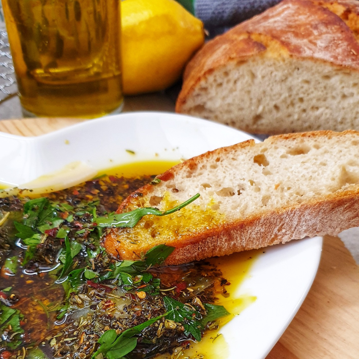 herbed olive oil bread dip on a white plate