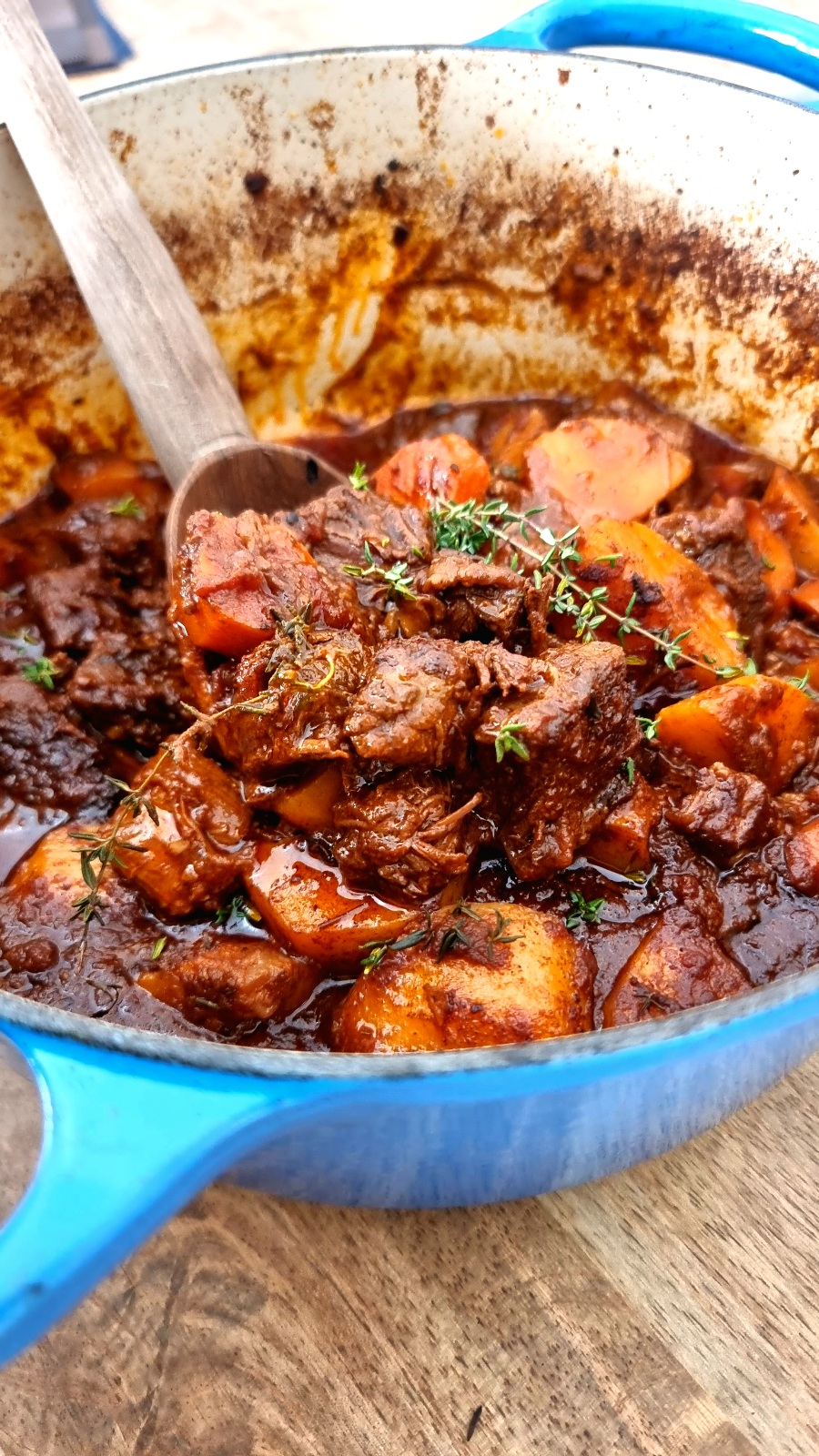 beef stew with potatoes, carrots and large spoon