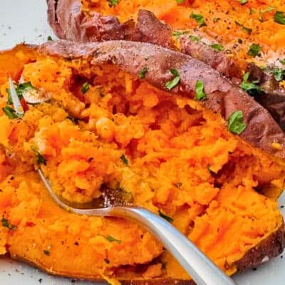 baked air fryer sweet potato skin-on with a fork