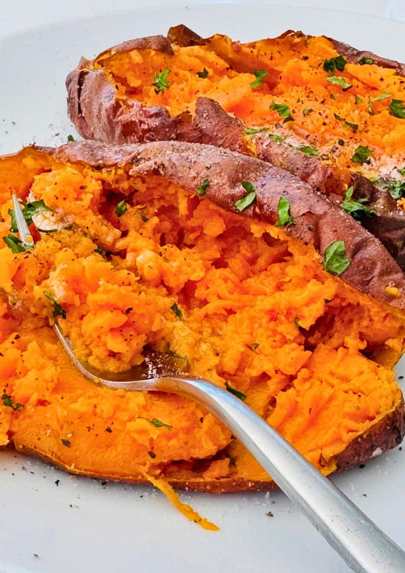 baked air fryer sweet potato skin-on with a fork