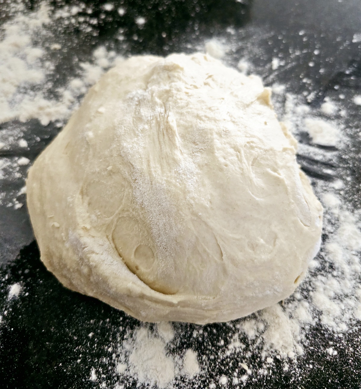 ball of dough on a floured surface for naan bread or calzone pizza