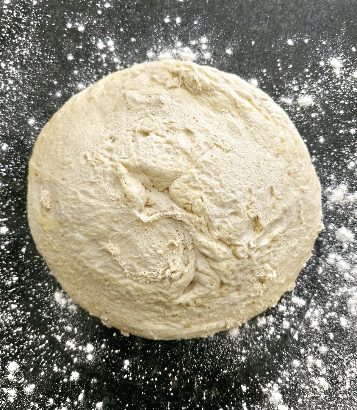 soft dough on a surface to be divided for naan bread