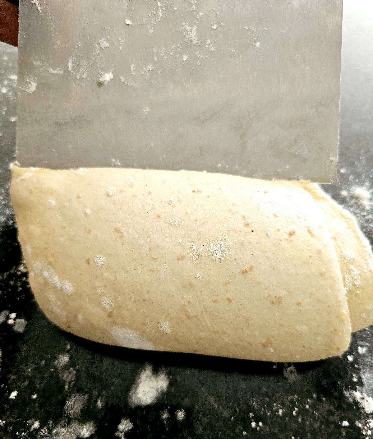 a picture of homemade dough being divided for naan bread