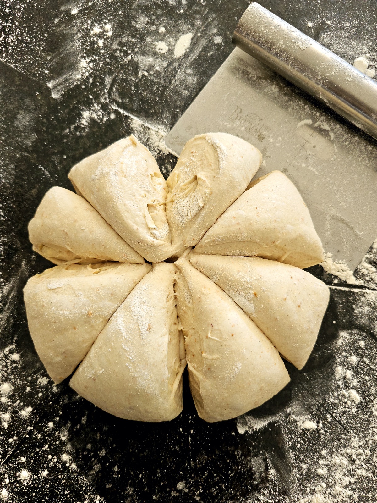 a picture of homemade dough divided into 8 parts for naan bread recipe