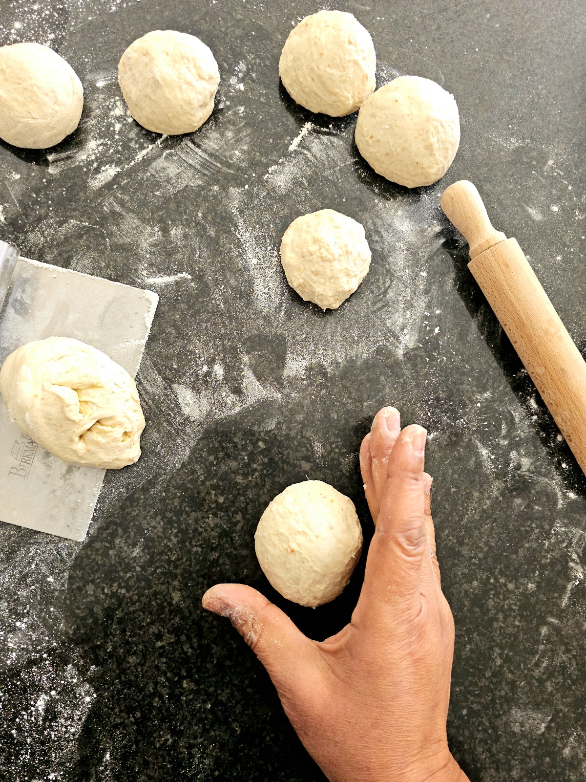 hand shaping dough for naan bread recipe