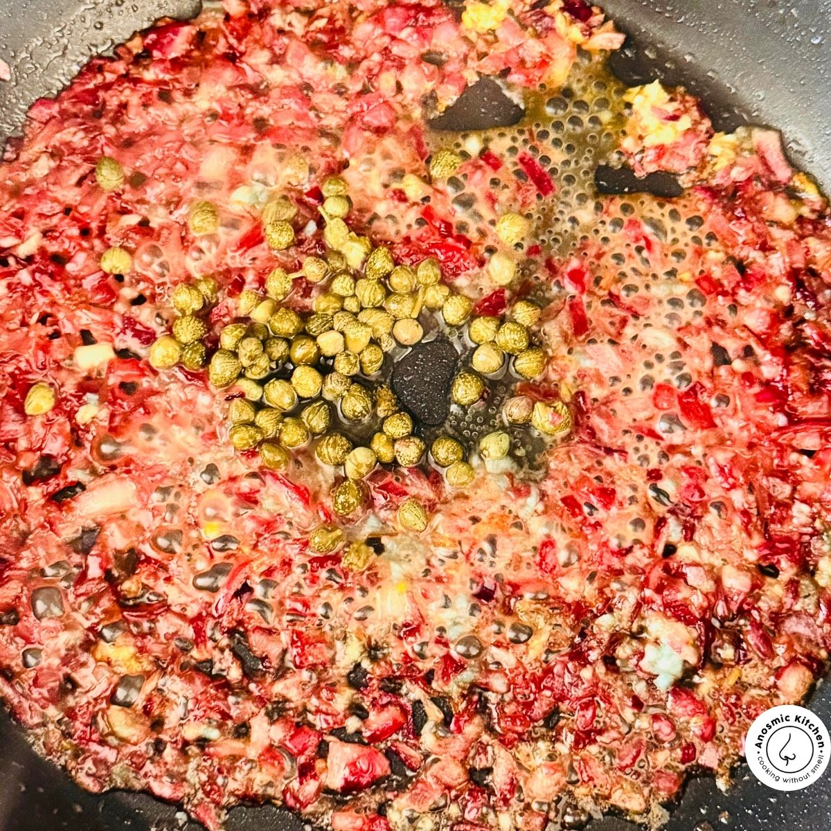 onion garlic and capers in frying pan