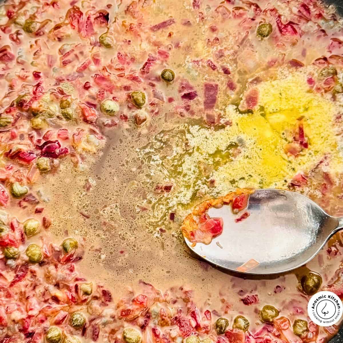 aromatics with butter frying in pan