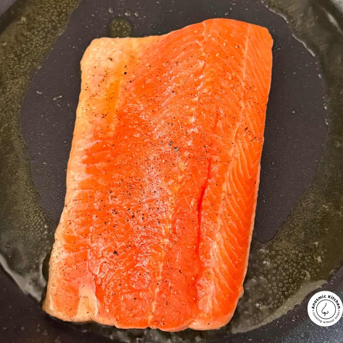 skin side down salmon in pan