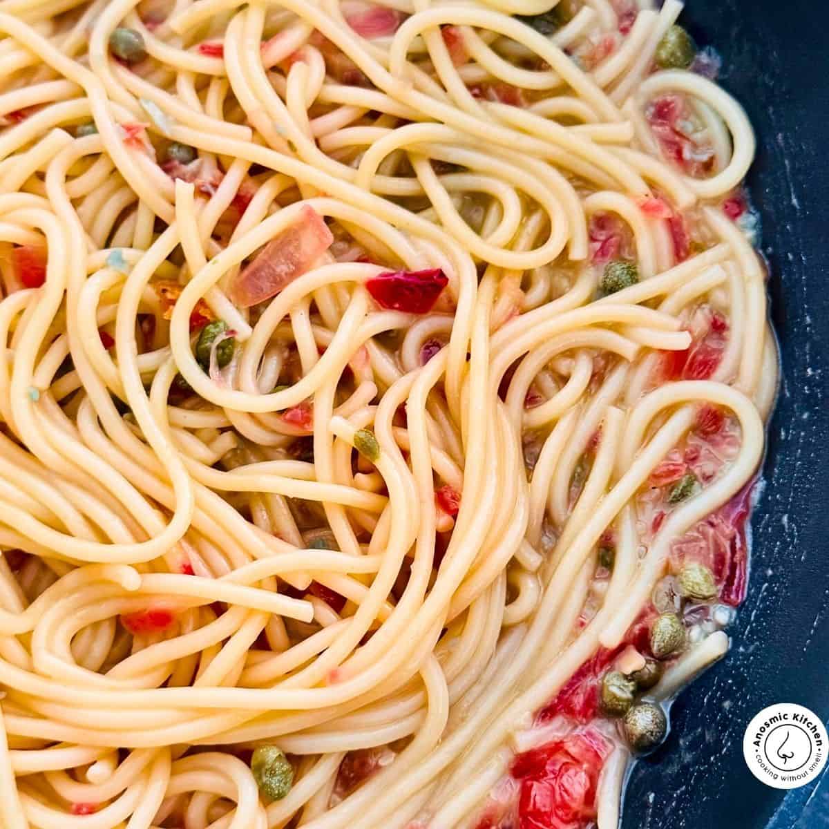 cooked spaghetti on simmer with aromatics