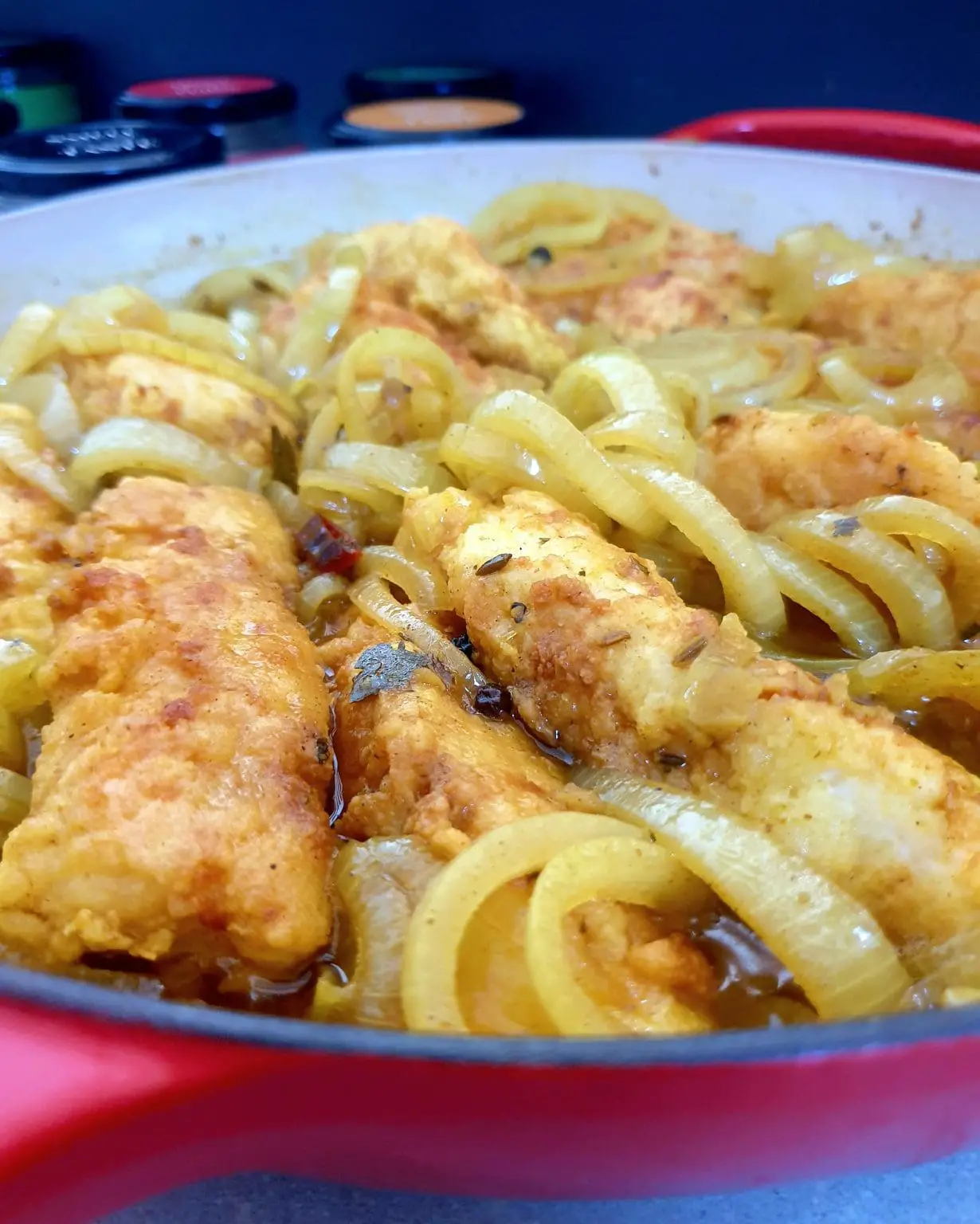 Cooked pickled fish and onion curry in a skillet, ready to serve