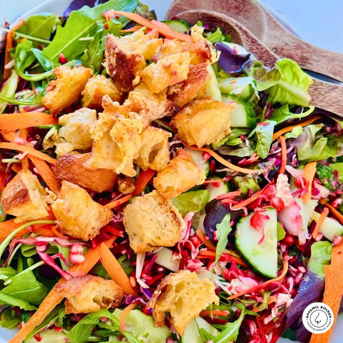 croutons on a pile of leafy green salad