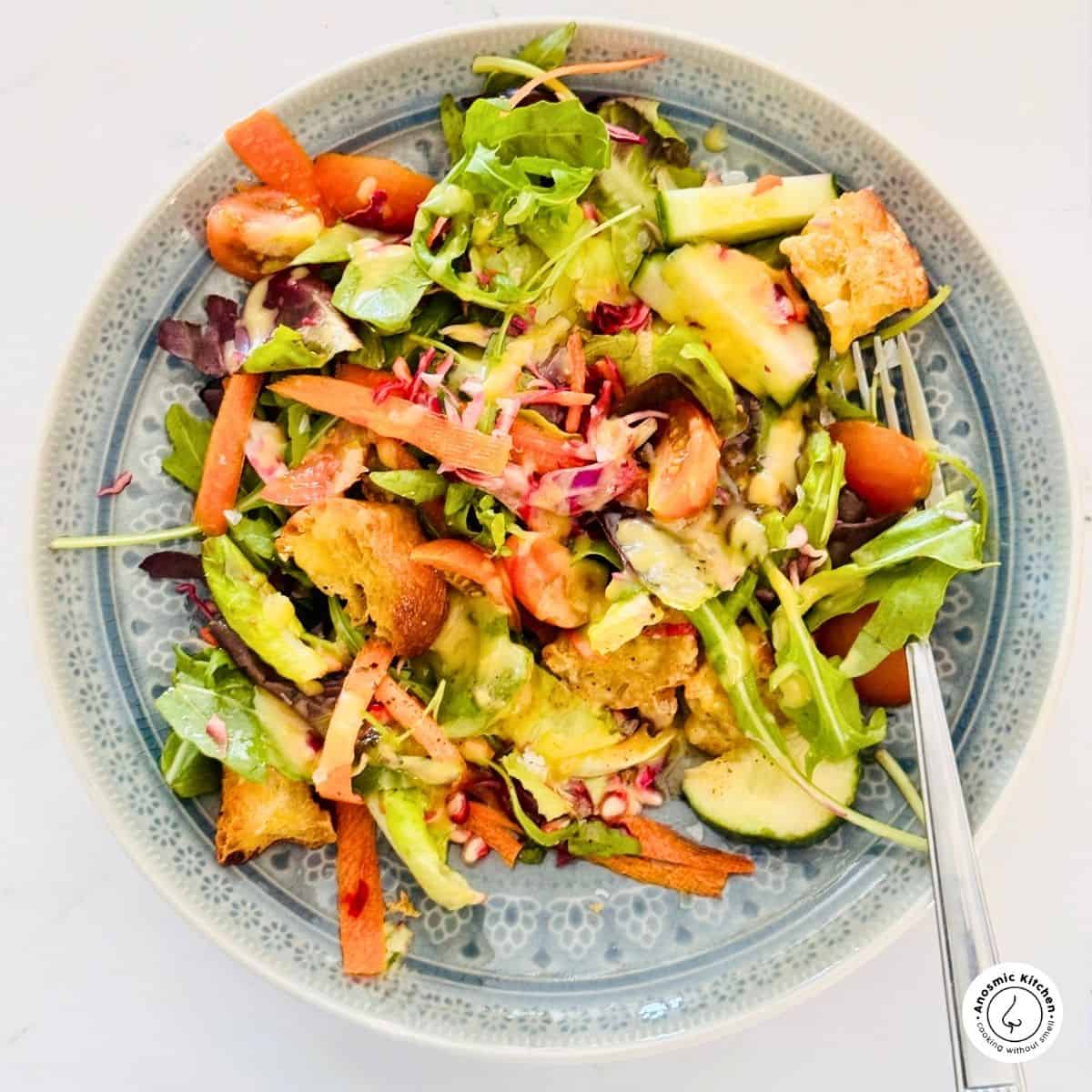 mixed leafy greens on a plate with a fork