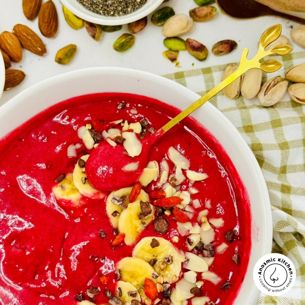 beetroot smoothie bowl with banana and seeds with a spoon