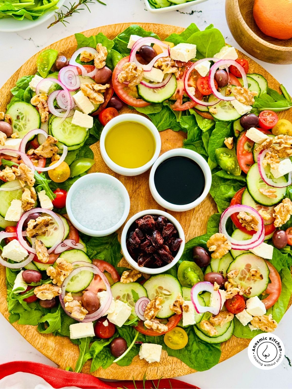 salad ingredients shaped in a wreath for christmas and served on a board.