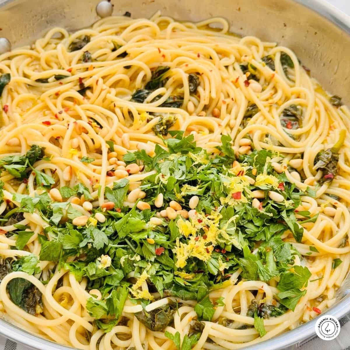 spaghetti spinach and fresh parsley in a pan