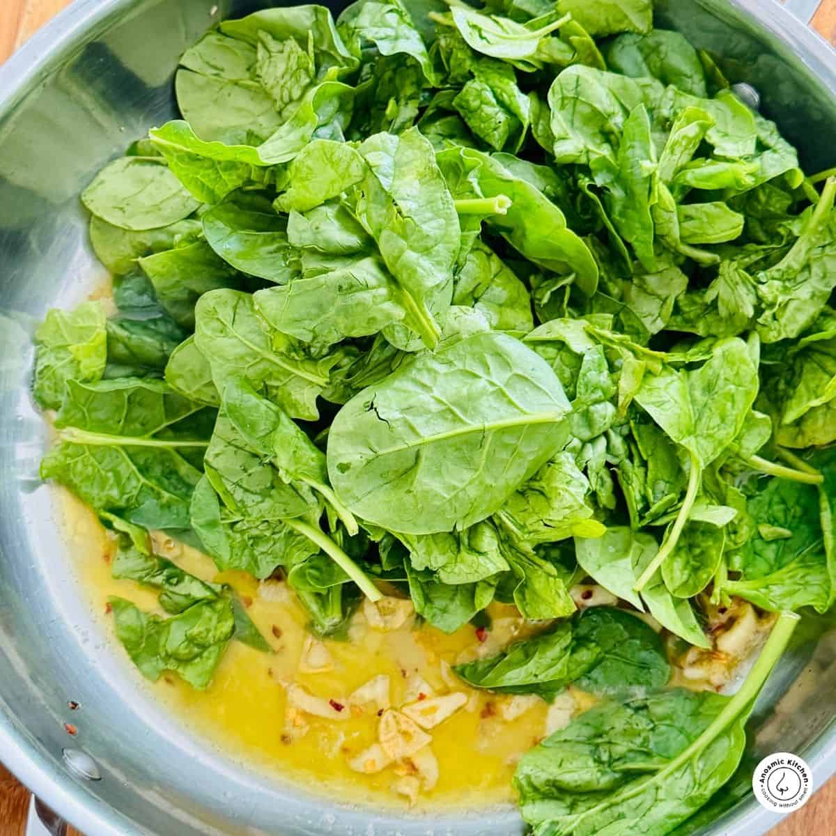 garlic, red pepper flakes and olive oil in a skillet with spinach