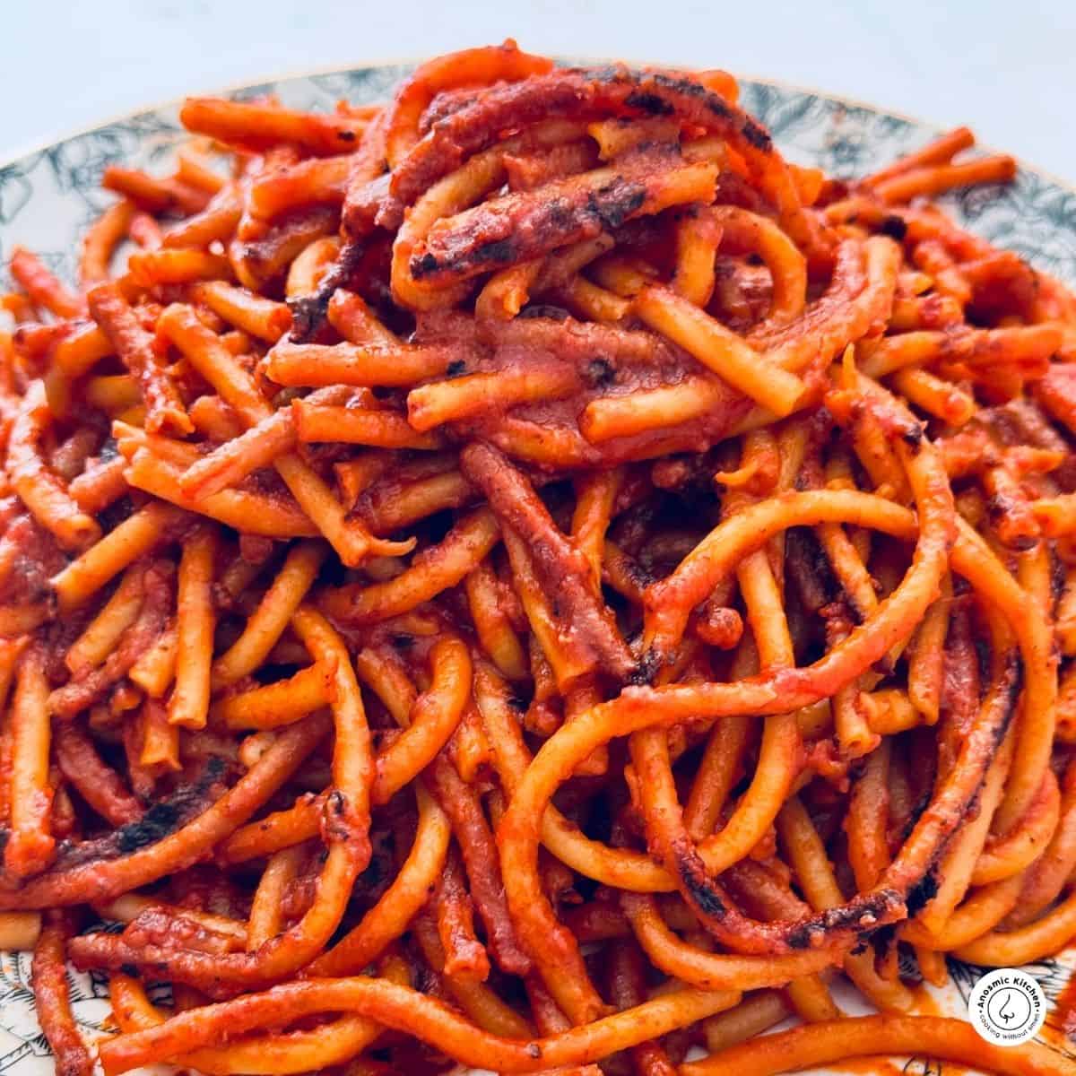 bucatini all'assassina piled high on a plate