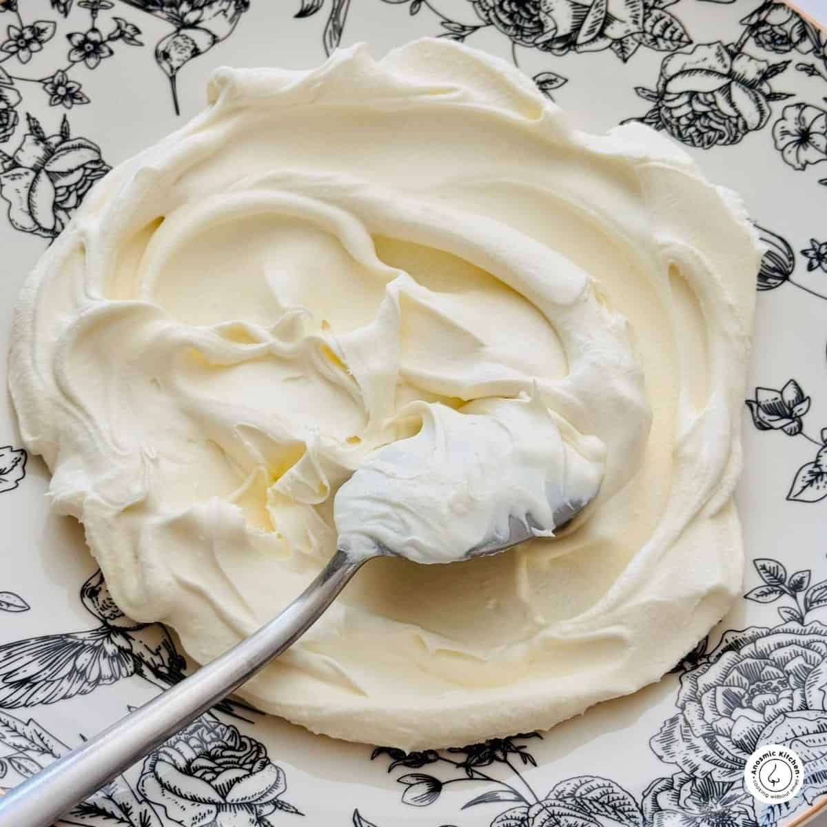 artisinal white and creamy mascarpone cheese on a black and white floral plate