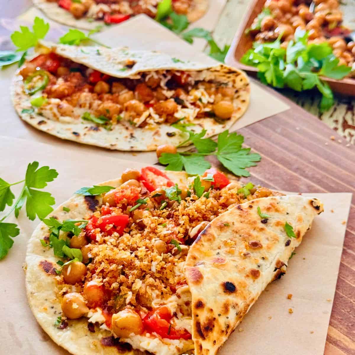 chickpea tahini wraps on a board with fresh parsley for deco