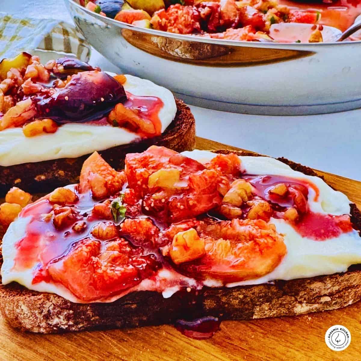 figs with mascarpone cheese on sourdough bread on a board.