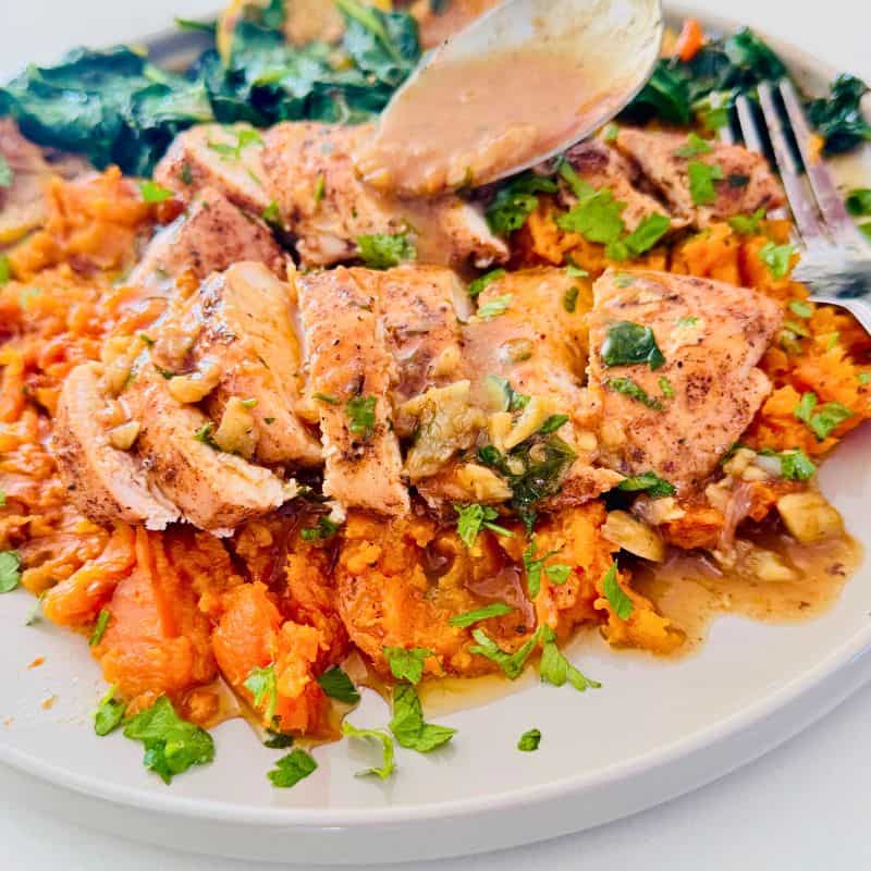 sliced baked chicken breast served over sweet potato mash and sauce