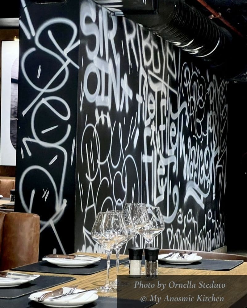 Interior of Bo-Vine restaurant, Cape Town, showing table setting and wall art