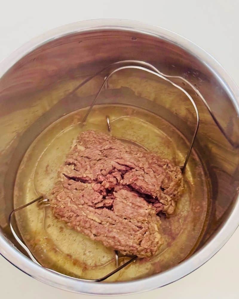frozen beef mince in instant pot over the trivet with water in.