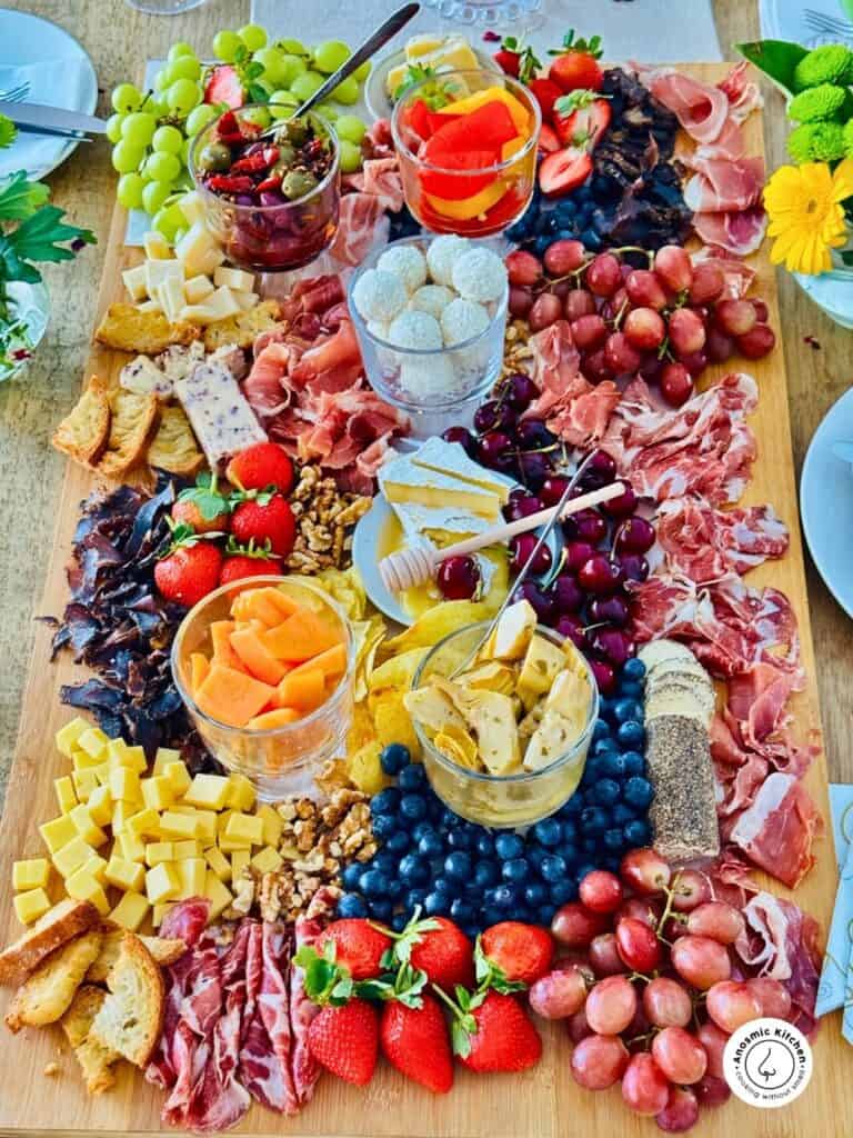 grazing board packed with cured meats, fruit, cheese and more