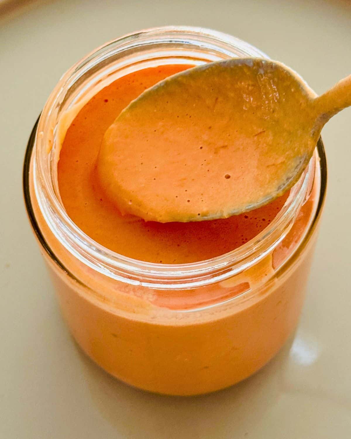 Close-up of creamy pink sauce in a glass jar