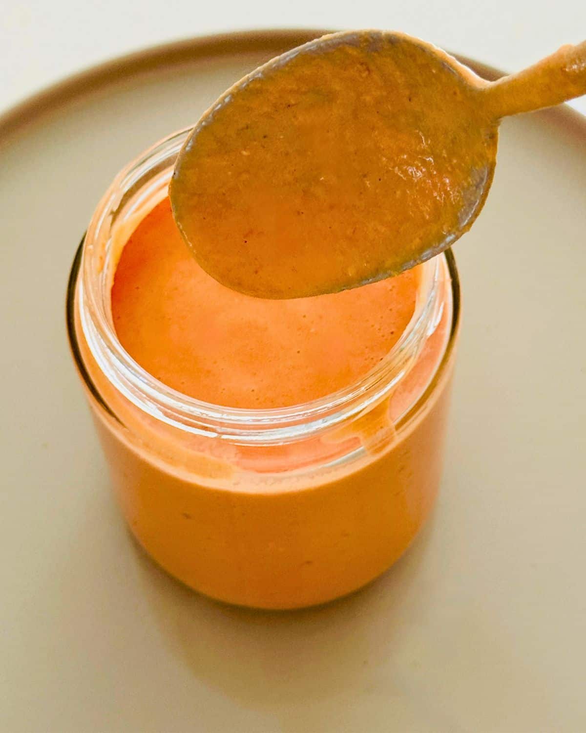 Close-up of creamy pink sauce in a glass jar