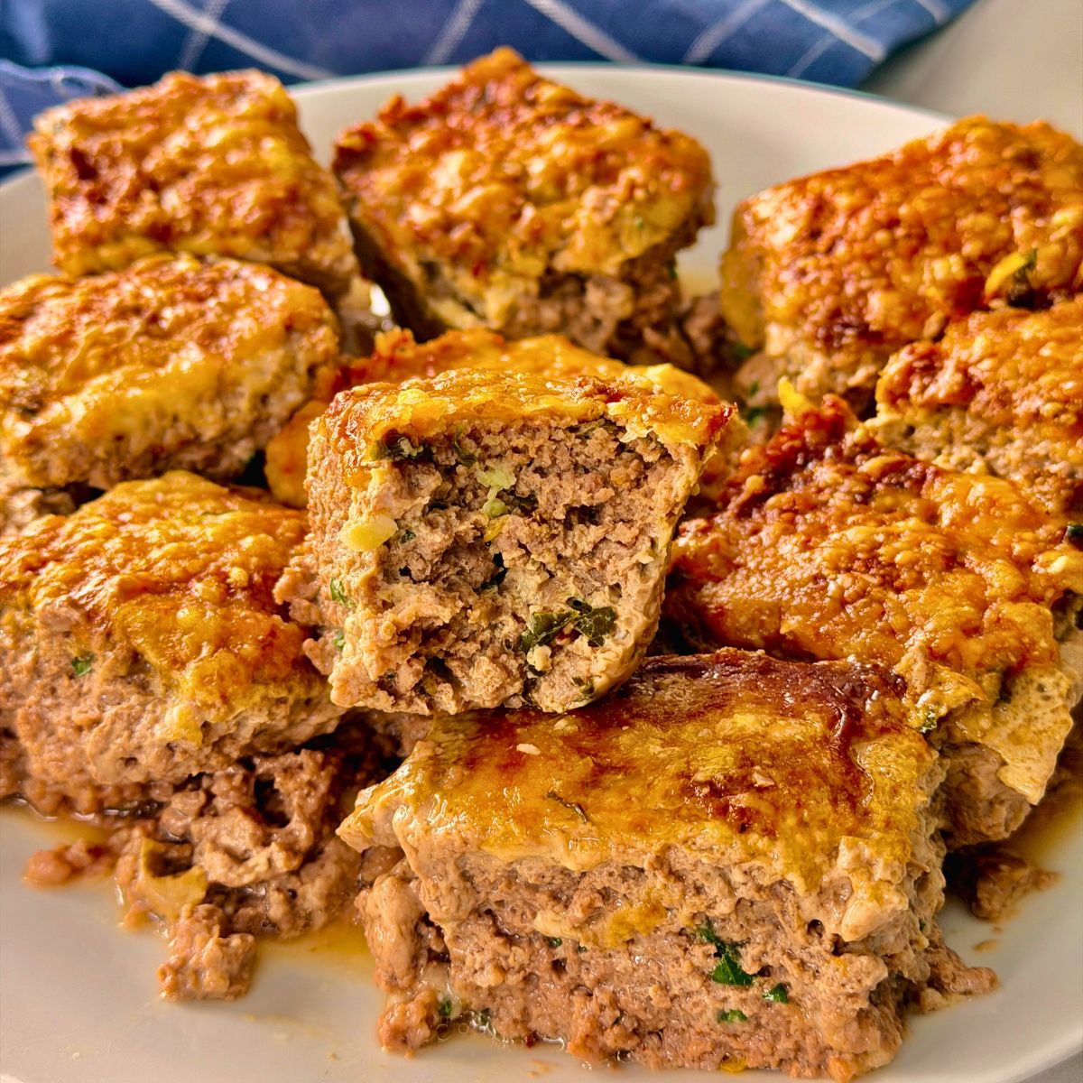 air fryer beef bites piled on a plate with one bitten into.