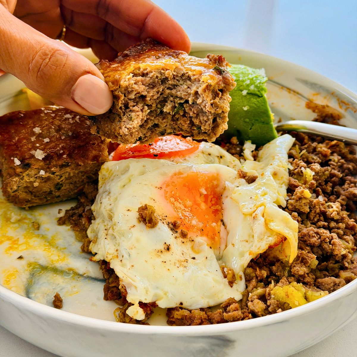 air fryer beef bites with egg and avo and ground beef in a plate