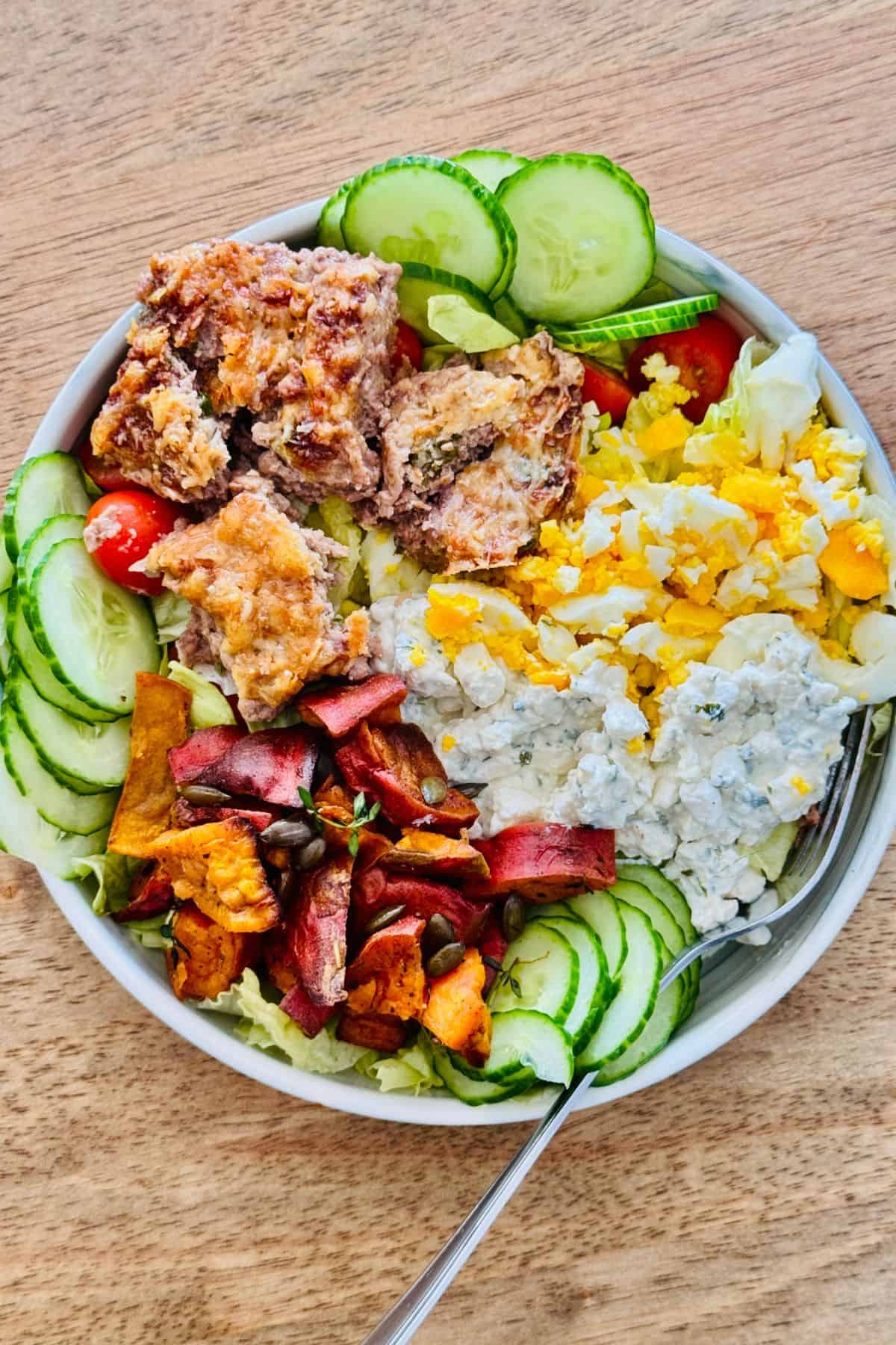 a bowl of salad topped with air fryer beef bites