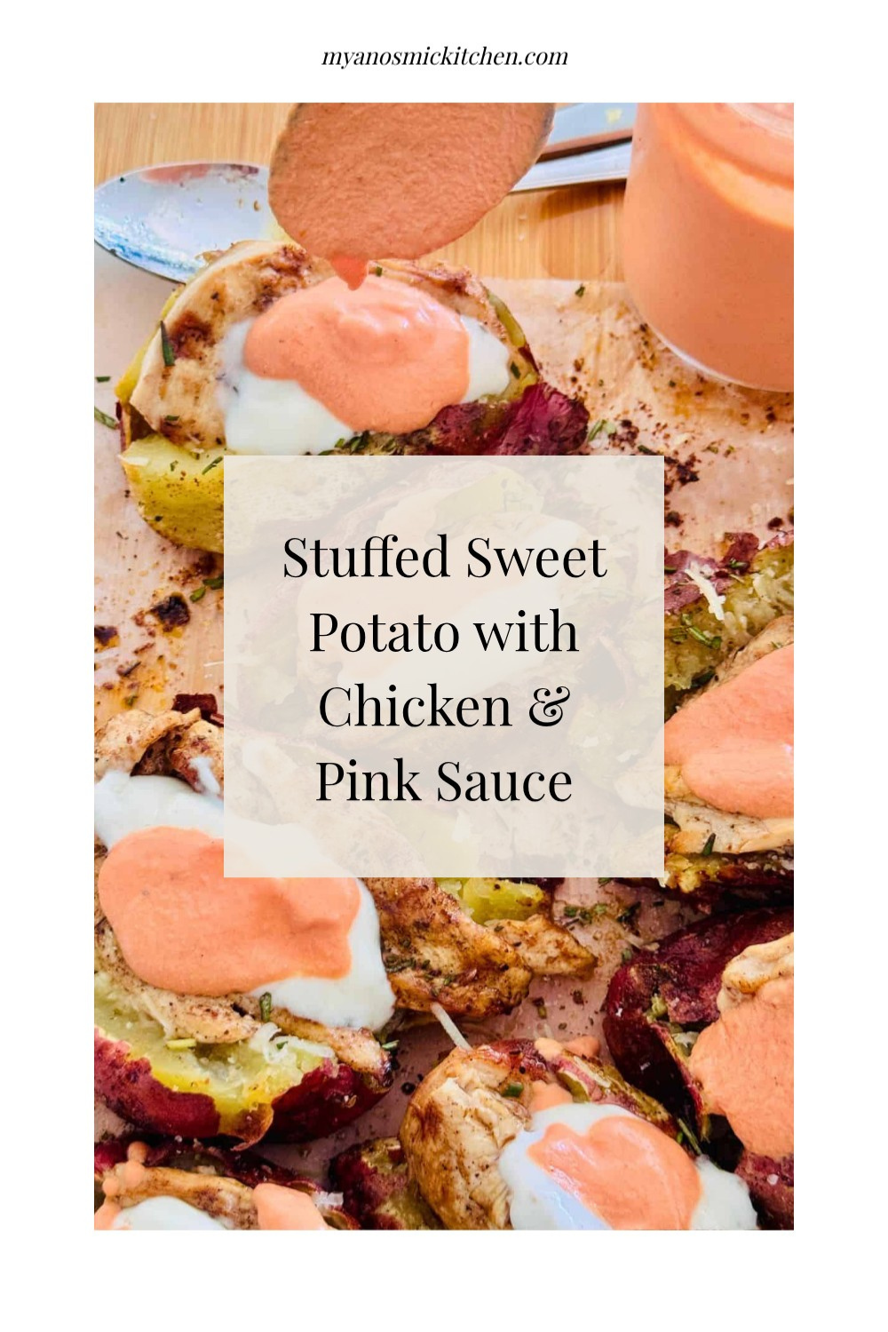 baked sweet potato stuffed with chicken and cheese with a pink sauce and yogurt drizzled over.