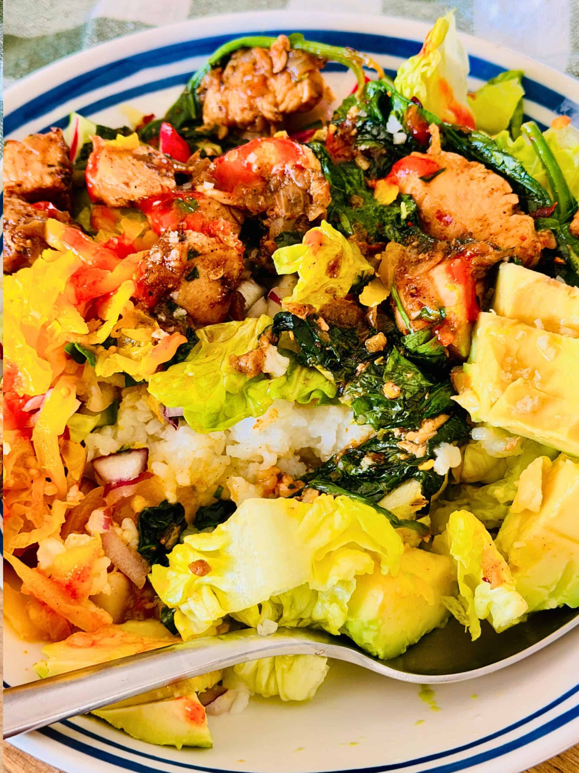 chicken and rice bowl with pickles and avocado